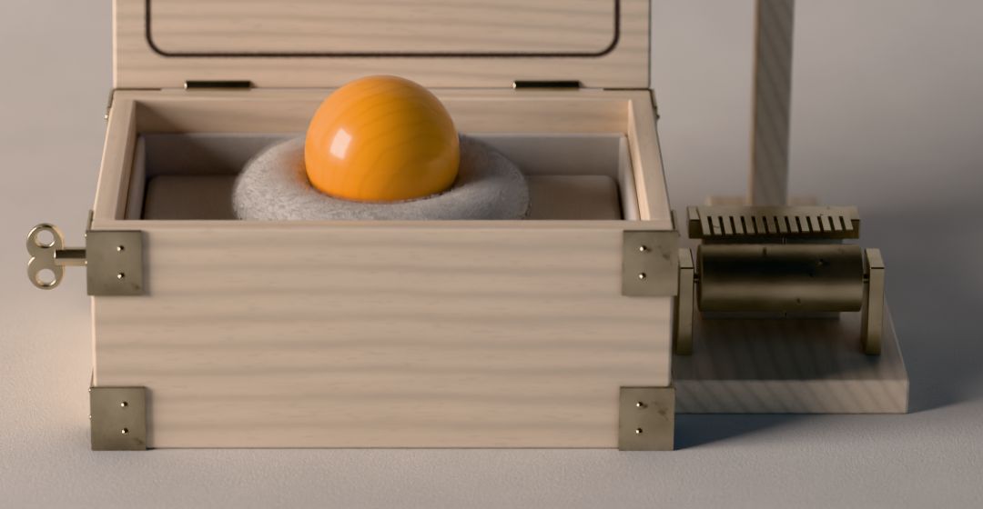 La bola de haya descansa en su nido de fieltro, dentro de la caja de música de madera con esquineras de latón; a la derecha, el cilindro de púas.