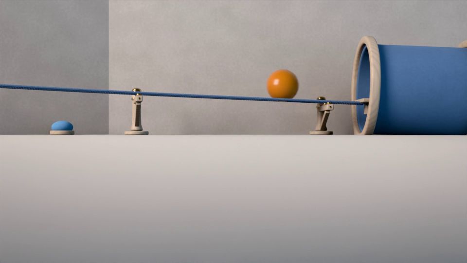 La bola llega por la cuerda a la boca de un túnel corto de fieltro azul con un aro de haya.